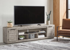Family Deals Furniture - Ashley Furniture - Naydell 92" TV Stand - 92" / Gray - W996-78