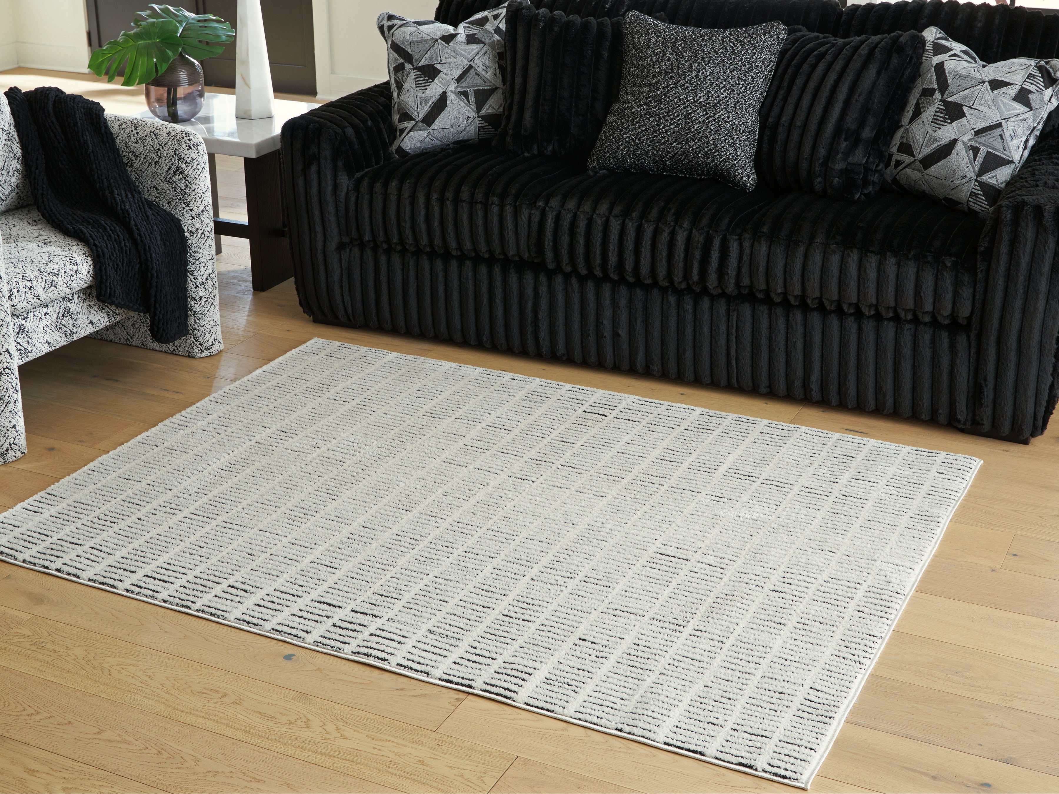 Family Deals Furniture - Ashley Furniture - Turinwith Rug - 5'3" x 7' Area Rug / Ivory/Black - R407552