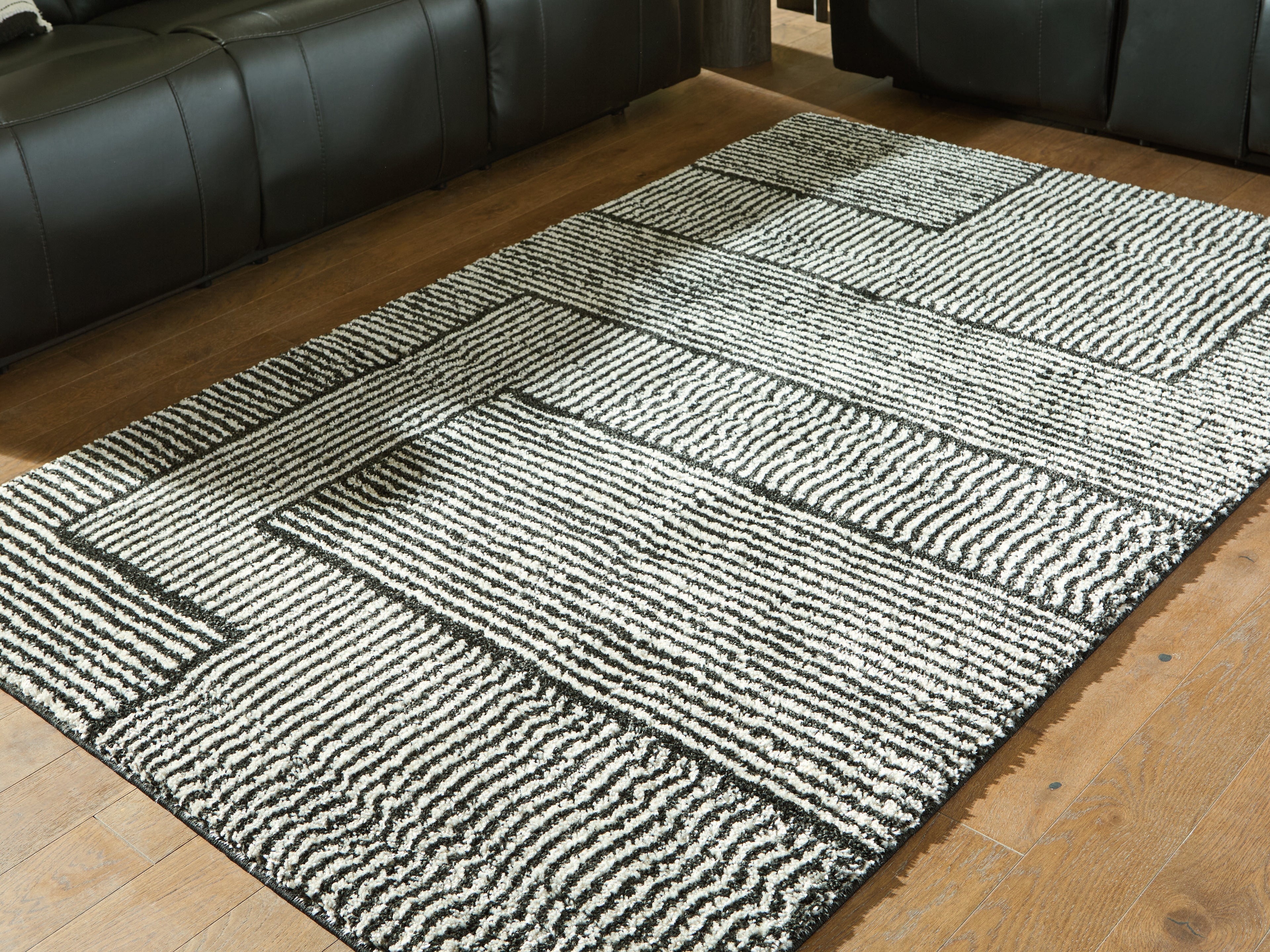 Family Deals Furniture - Ashley Furniture - Kurtmen Rug - 5' x 7' Area Rug / Black/Ivory - R407592